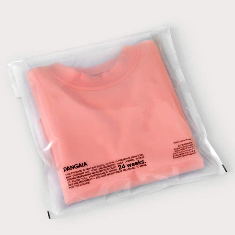 open flap pouch packaging with a light orange jumper inside