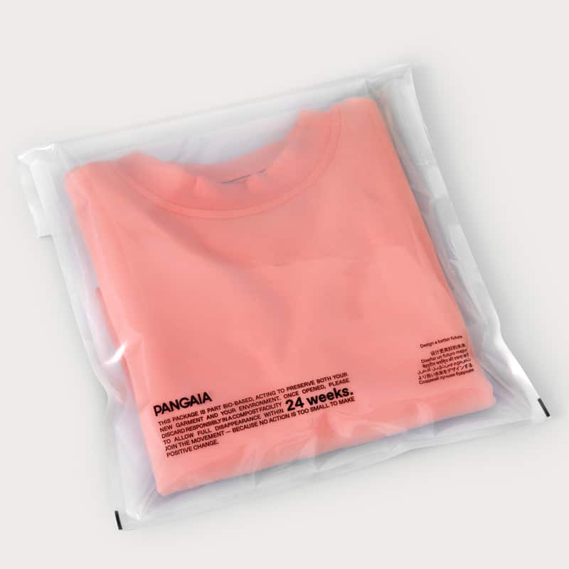 open flap pouch packaging with a light orange jumper inside