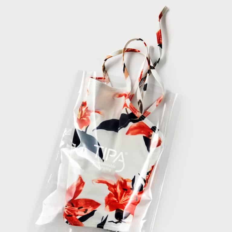 open pouch clothes packaging with a floral pattern white dress inside
