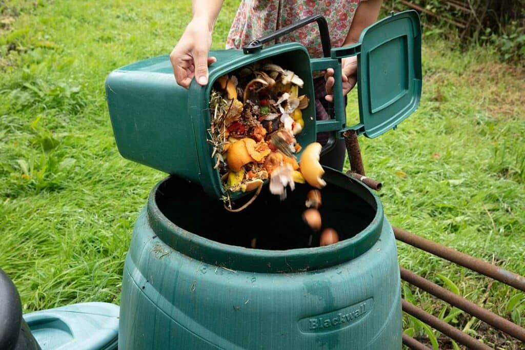 putting compost into a bin