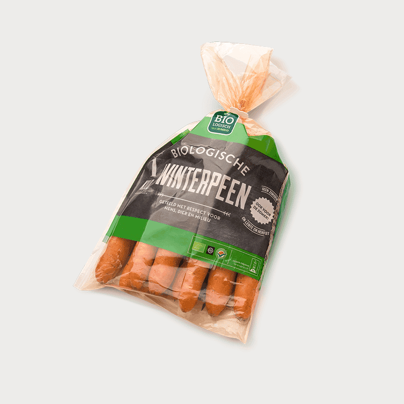 Eco-friendly bag on a reel for food with ventilation holes, filled with carrots.